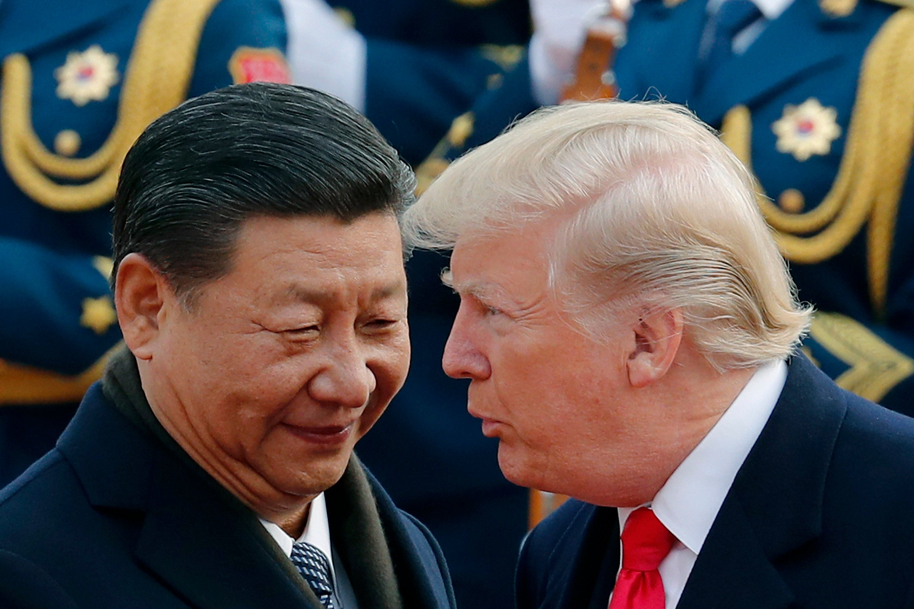 FILE - President Donald Trump, right, talks with China’s President Xi Jinping during a welcome ceremony at the Great Hall of the People in Beijing, Nov. 9, 2017. (AP Photo/Andy Wong, File)